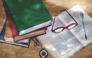 Books, eyeglasses, watch, pen